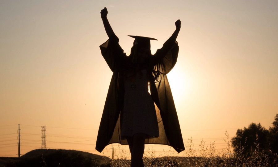 The sky is the limit. Graduate. Complete. Graduation. Hands up. Empowered woman. Finished school.